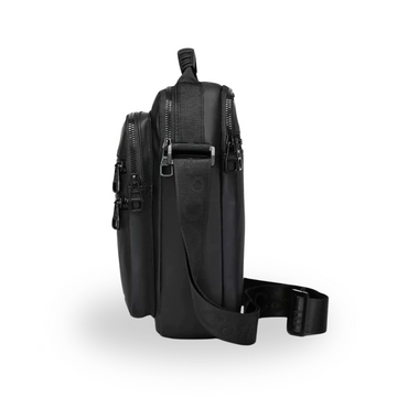 Black crossbody bag with multiple zippers and adjustable strap for travel or daily use