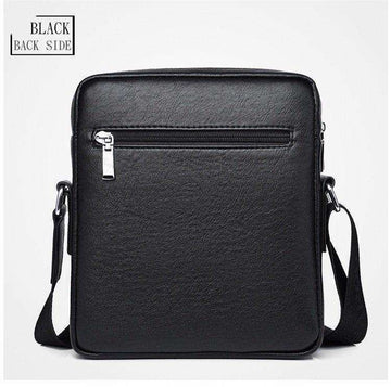 Black leather crossbody bag with front zipper pocket and adjustable strap, back view.