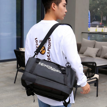Black FEIHONGGU duffel bag with shoulder strap, ideal for travel and gym use