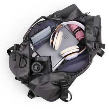 Black travel backpack with laptop, headphones, camera & umbrella inside, ideal for students and travelers