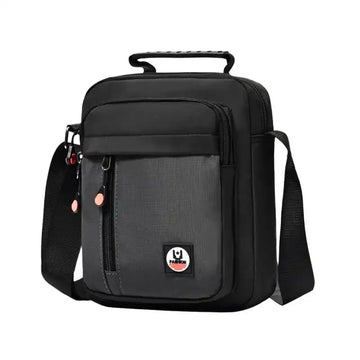 Black crossbody bag with adjustable strap, front pocket, and top handle for travel or daily use