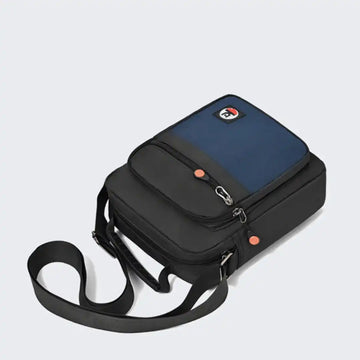 Compact black and blue crossbody bag with adjustable strap and front pocket, ideal for travel or daily use.