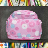Pink polka dot student backpack with school supplies, ideal for school or travel