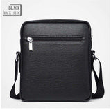 Black leather crossbody bag with front zipper pocket and adjustable strap, back view.