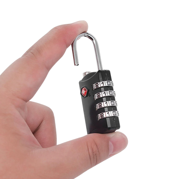 Hand holding a black combination lock on a white background