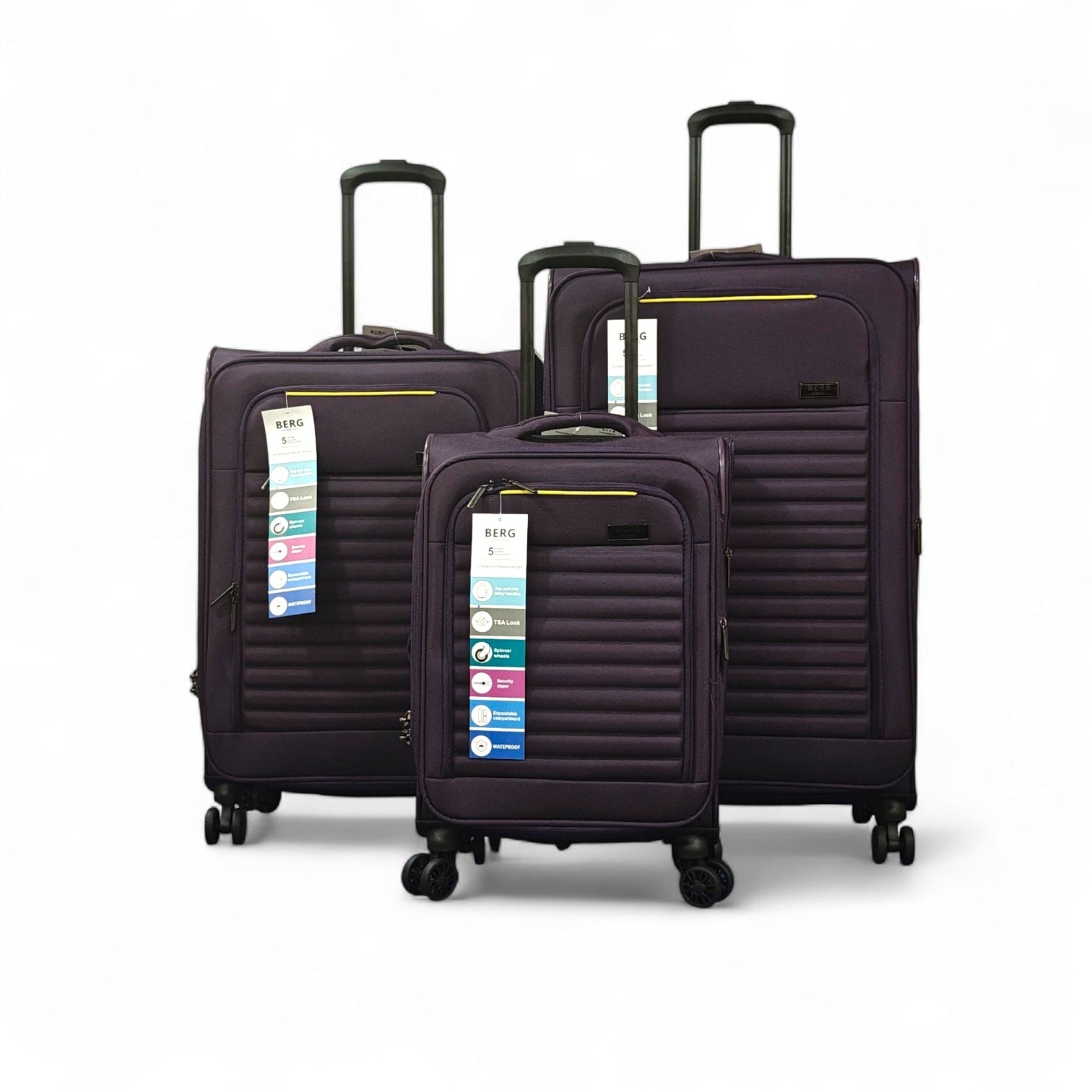 Three purple suitcases with tags on a white background