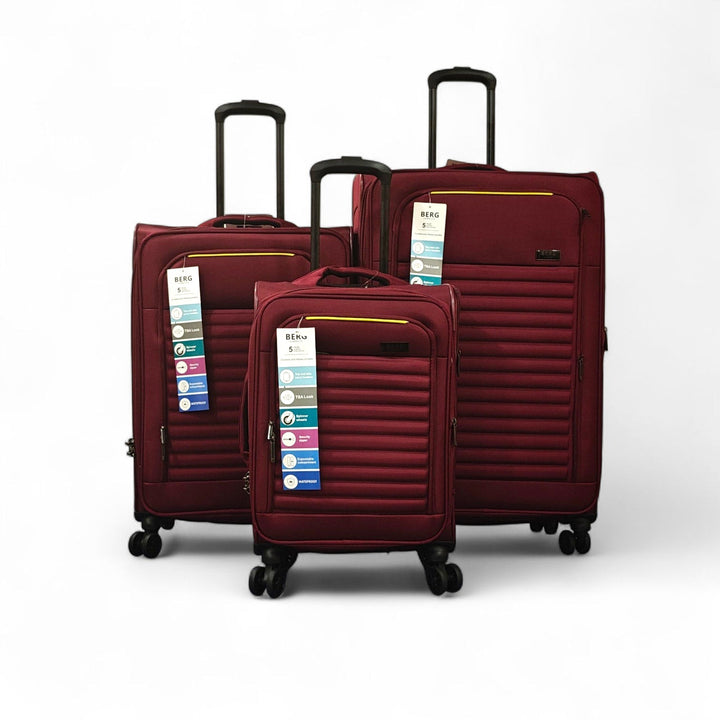 Three maroon suitcases of different sizes on a white background