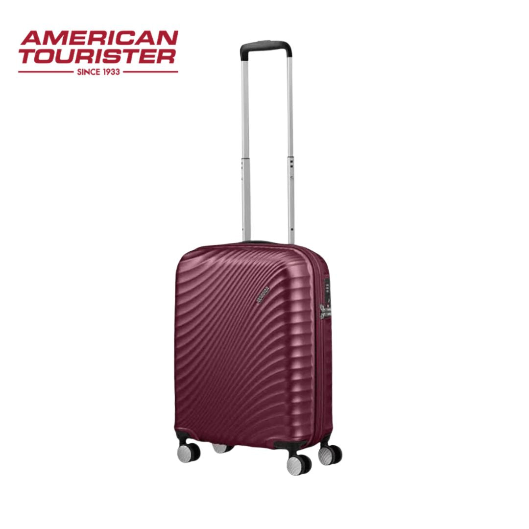 American Tourister burgundy hardshell suitcase with 4 spinner wheels and extendable handle