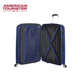 American Tourister blue hard-shell suitcase with open interior, mesh pockets, and spinner wheels
