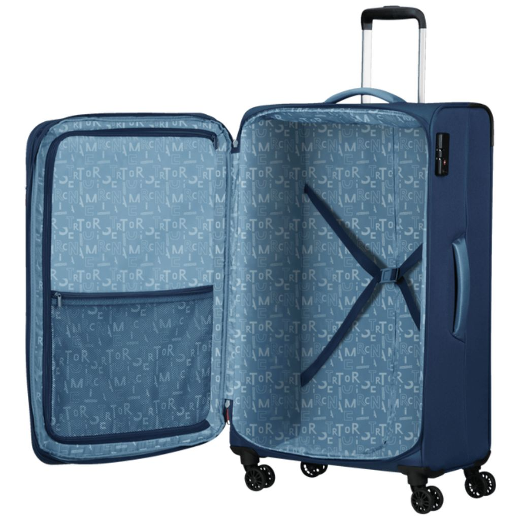 Blue hard-shell suitcase with patterned interior, spinner wheels, and extendable handle for travel