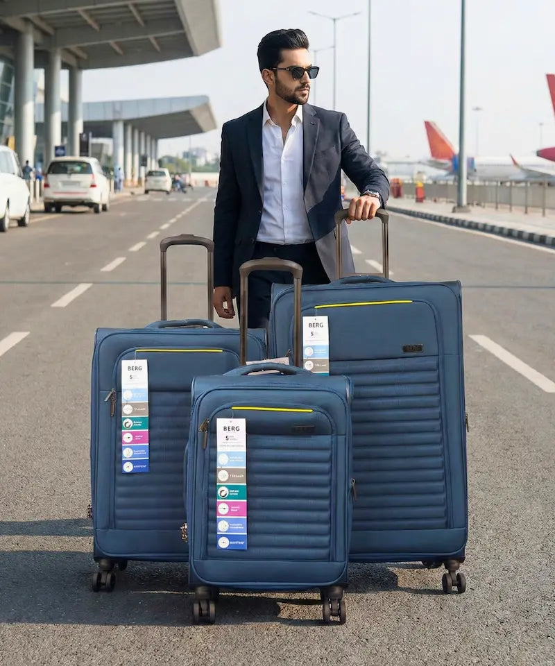 Man with blue suitcases at an airport