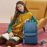 Blue student backpack with front pocket, ideal for school or travel, shown with girl reading book