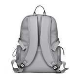 Gray travel backpack with padded straps and side pockets, ideal for students and laptop carry