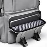 Gray laptop backpack with striped interior pocket, ideal for students and travel