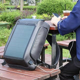 Solar-powered travel backpack charging phone outdoors, ideal for students and travelers