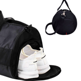 Black duffel gym bag with shoe compartment, ideal for travel & fitness, shown with white sneakers