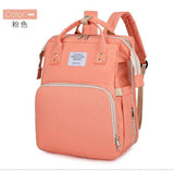 Peach pink backpack with large front pocket, side pockets, and top handles for travel or school.