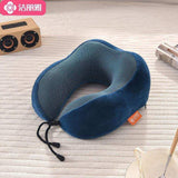 Blue memory foam travel neck pillow on a light fabric surface, ideal for luggage and travel