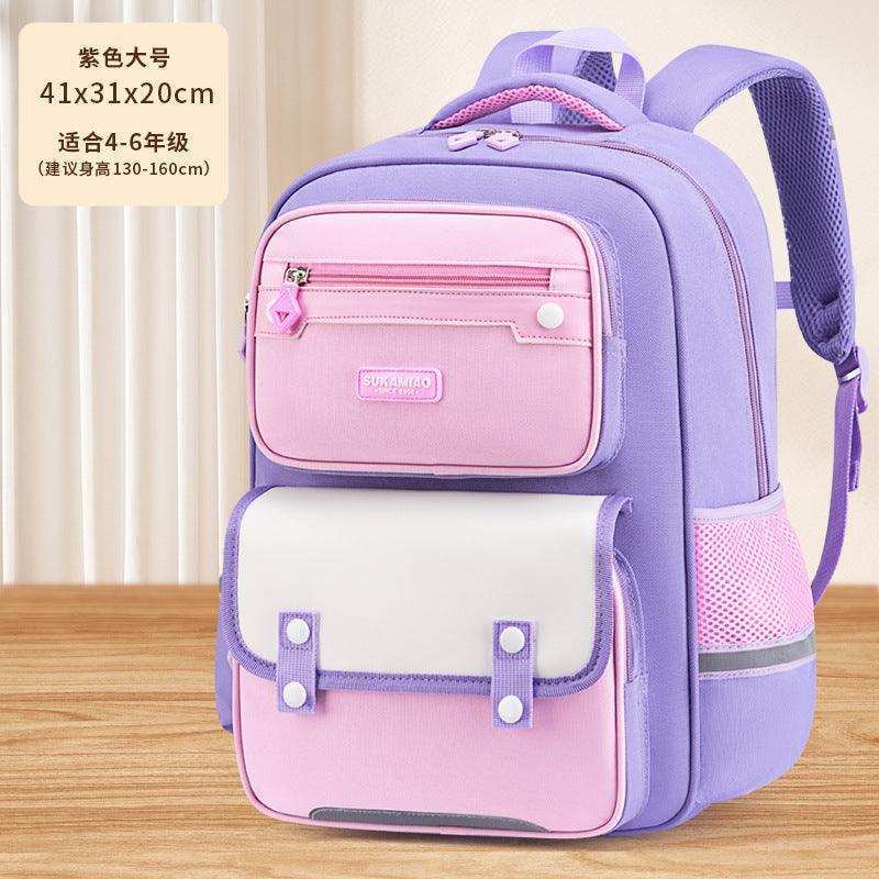 Purple and pink school backpack for kids with multiple pockets, displayed on wooden surface.