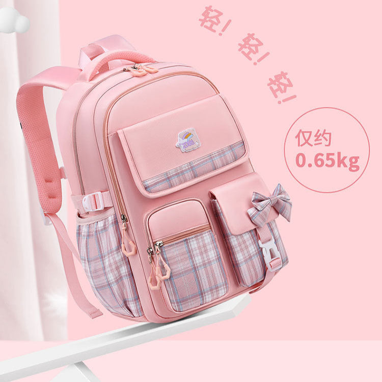 Lightweight pink student backpack with plaid pockets, bow detail, and 0.65kg weight label for school or travel