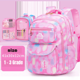 Pink tie-dye school backpack for grades 1-3 with multiple pockets, heart zipper pull, and unicorn design