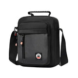 Black crossbody bag with adjustable strap, front pocket, and top handle for travel or daily use