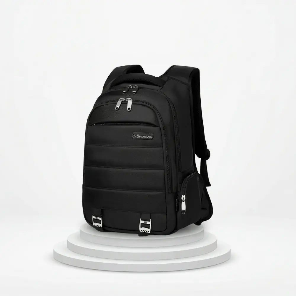 Black backpack on a white pedestal with a white background