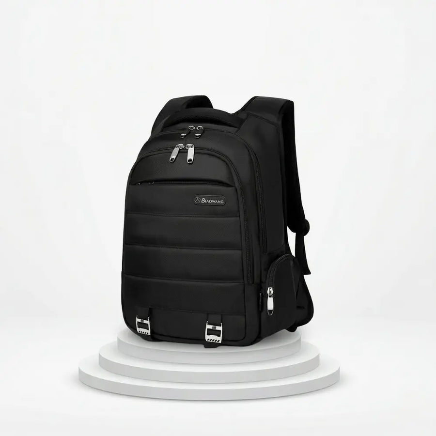 Black backpack on a white pedestal with a white background