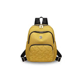 Yellow quilted travel backpack with black straps, ideal for students and laptop carry