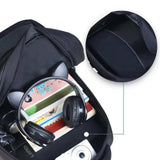 Open black school backpack with headphones, books, camera, and organized compartments