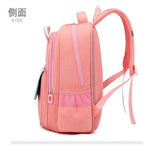 Pink student backpack with side pocket and mesh straps, ideal for school or travel