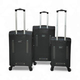 Set of three black hardshell travel suitcases with extendable handles and spinner wheels