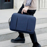 Navy blue laptop briefcase bag for travel or work, carried by person on stairs