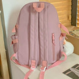 Pink student backpack with side pockets and adjustable straps, ideal for school or travel