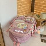 Pink student backpack with cute patches and plush toy, ideal for school or travel