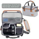 Gray camera bag with orange trim, padded interior holding DSLR, lens, and accessories, ideal for travel photography