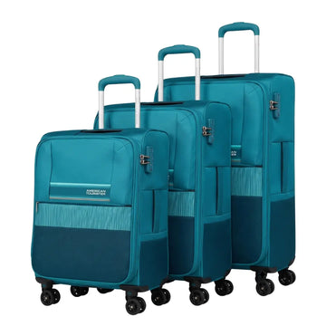 Three-piece American Tourister spinner luggage set in teal blue, featuring a softside carry-on, a medium suitcase, and a hardside suitcase, shown on a white background.