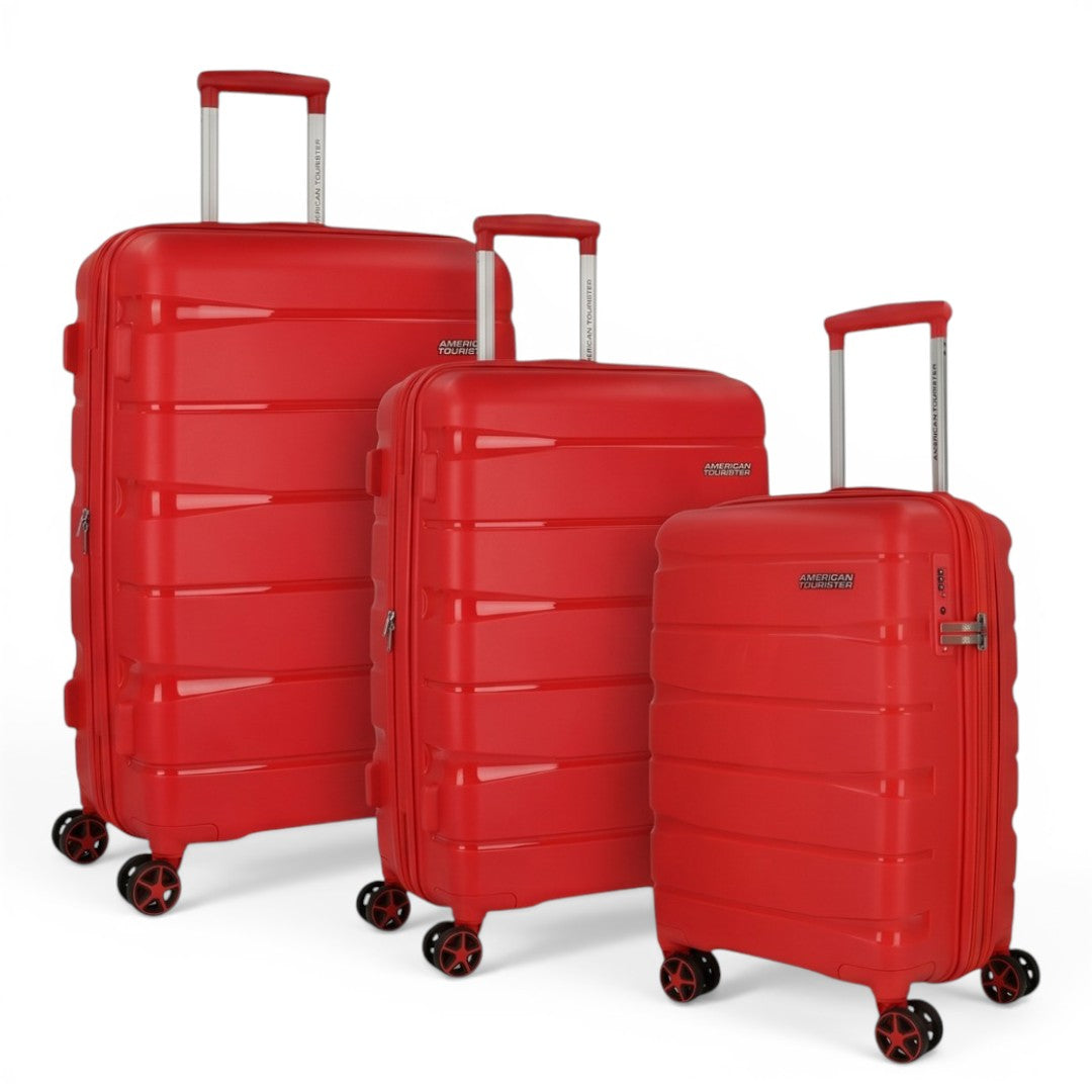 Red American Tourister hard shell luggage set with spinner wheels, ideal for travel and trips