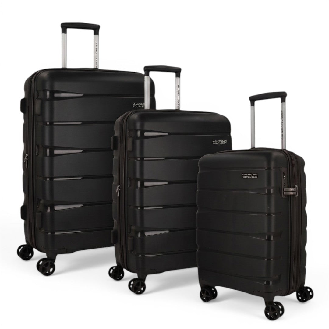 Black American Tourister hard shell suitcases with spinner wheels, ideal for travel luggage needs.