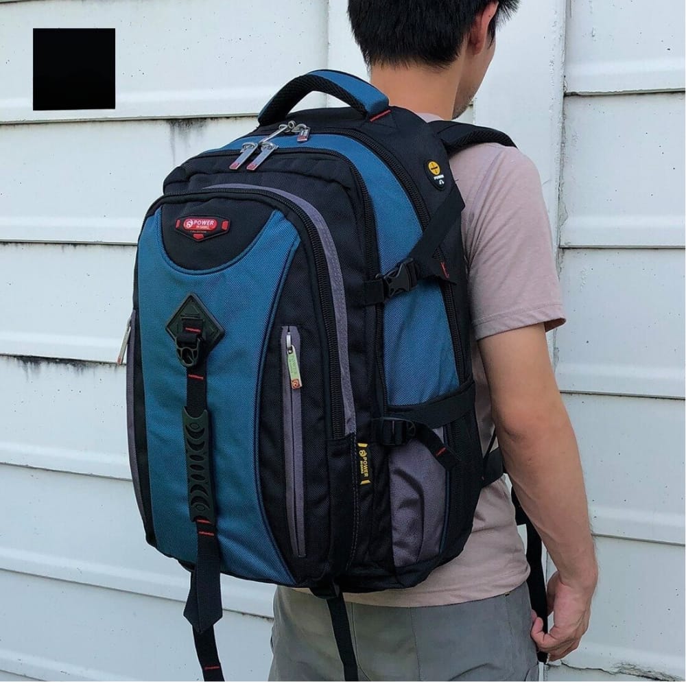 Blue and black travel backpack with multiple compartments, worn by man for school or laptop use