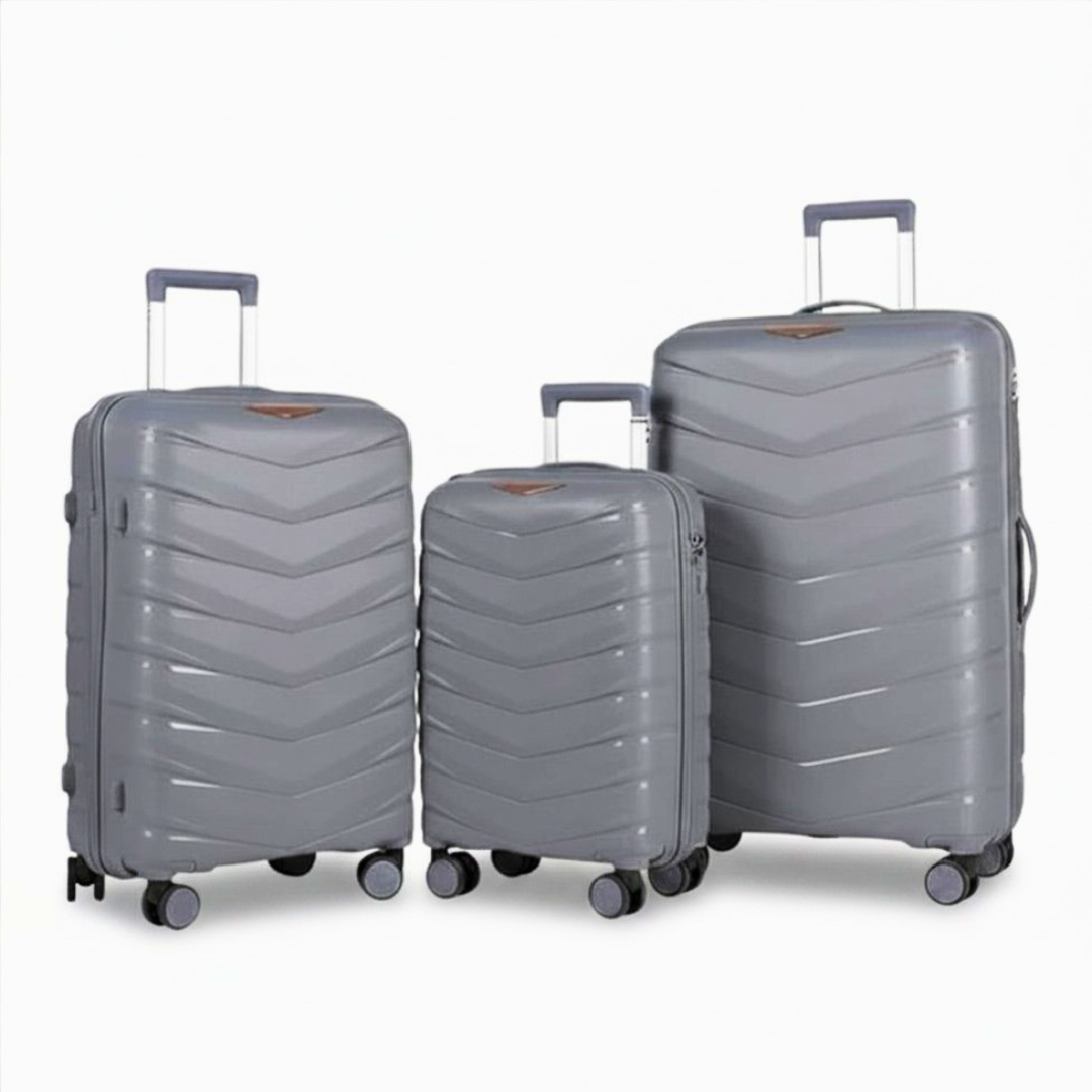 Grey hardshell luggage set with chevron design, spinner wheels, and extendable handles for travel