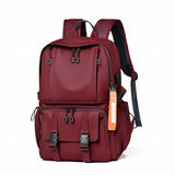 Burgundy travel backpack with multiple pockets, USB port, and adjustable straps for students and laptop carry