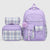 A lavender purple school backpack set with matching lunch bag and pencil case, featuring plaid pattern panels and a fuzzy pom-pom accent, shown on a light gray background.