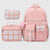 A pink school bag set with a backpack, a lunch bag, and a pencil case, all featuring a plaid pattern in pink, white, and light blue on a light gray background.