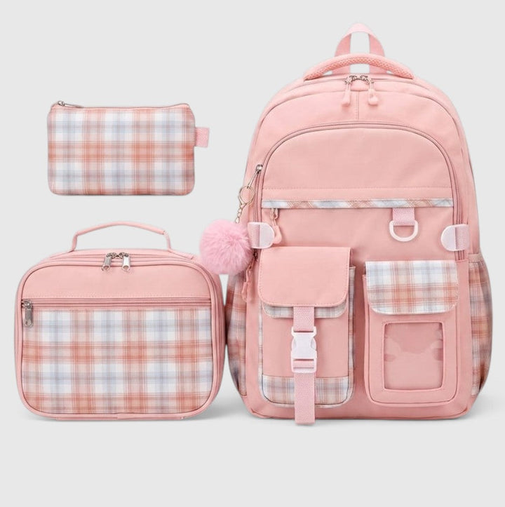 A pink school bag set with a backpack, a lunch bag, and a pencil case, all featuring a plaid pattern in pink, white, and light blue on a light gray background.