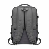 The back view of a dark gray laptop backpack, showing padded shoulder straps, a top carry handle, side compression buckles, and a breathable mesh back panel, set against a plain white background.